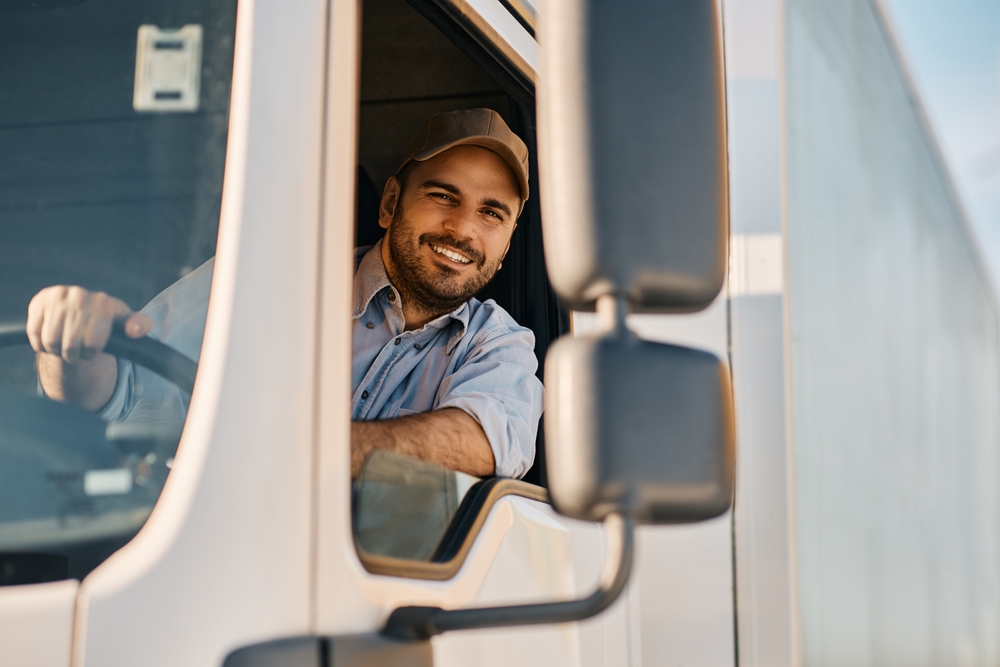 Happy,Professional,Truck,Driver,Driving,His,Truck,And,Looking,At